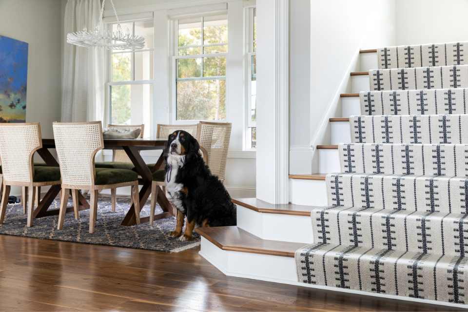 staircase and dining room with dog